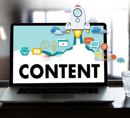 A laptop displaying the word 'CONTENT' with a rocket and various digital icons symbolizing creativity and online communication.