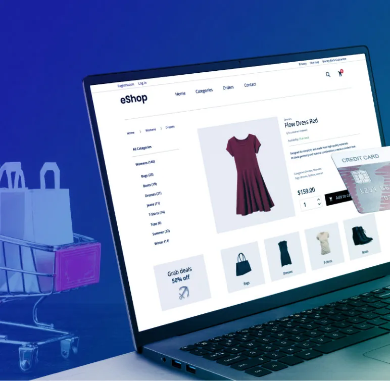 A laptop displays an online clothing store while a hand holds a credit card for checkout. A shopping cart with bags is in the background.